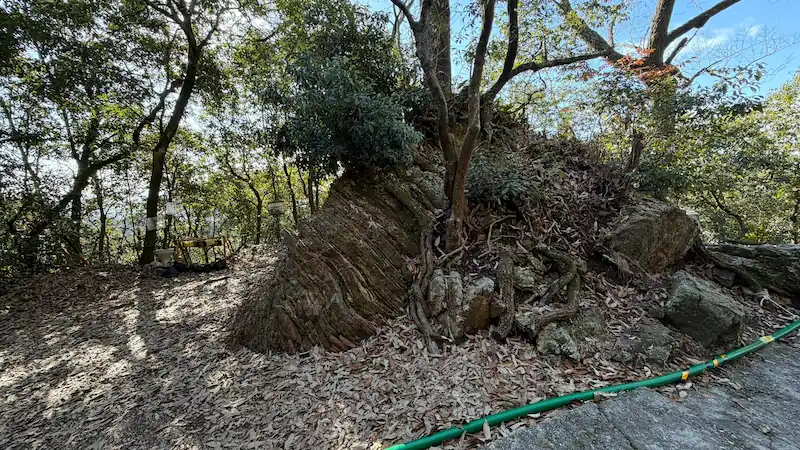 The area around the Presumed First Gate Ruins on the upper slope of Mount Kinka, showing fallen boulders and the surrounding path