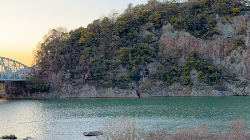 A mid-slope structure visible from the opposite bank (purpose unknown)