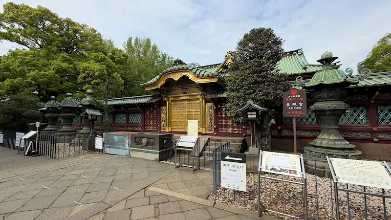 Full view of the Karamon Gate at Ueno Toshogu Shrine, with bronze lanterns lined up in front.