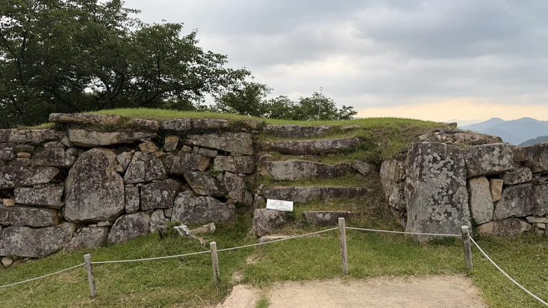 A stone wall and steps around Take-no-mon Gate Site.