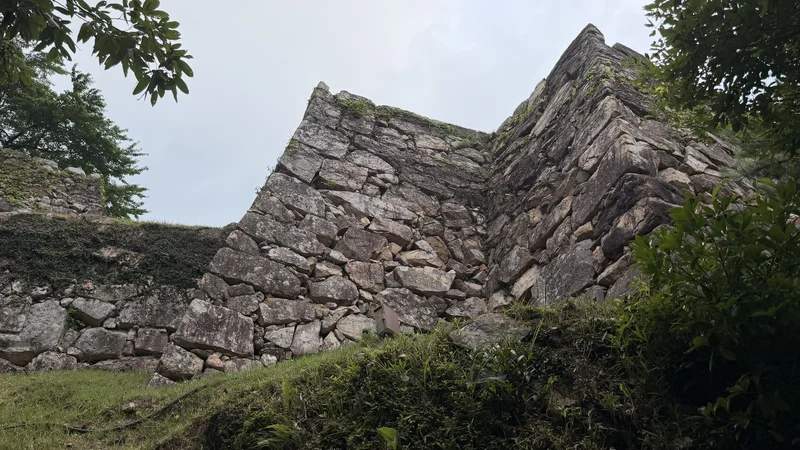 A stone wall corner surviving at Takeda Castle Ruins.