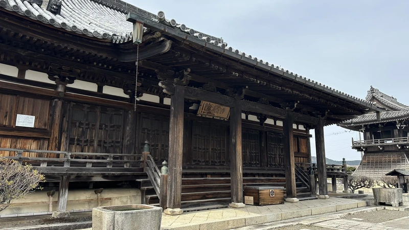 A close view of a large wooden hall at Jogon-in Temple, its deep eaves and carved wooden joinery drawing the eye.