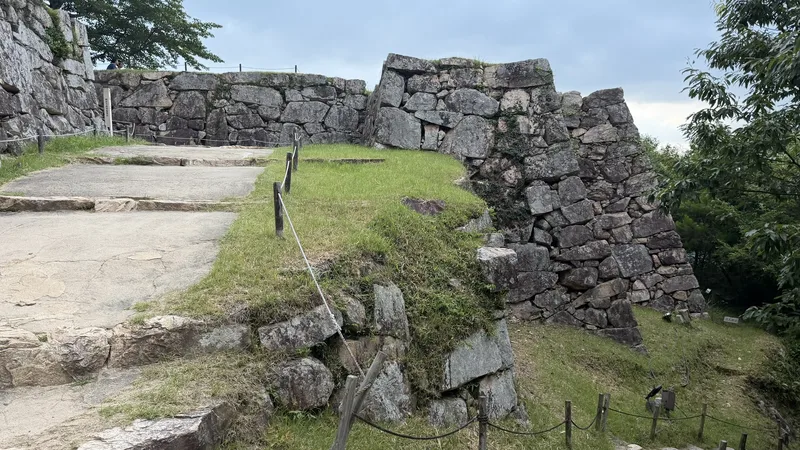 Stone steps and a narrow entrance flanked by stone walls near Mitsuke Turret Site, part of the original passage up into the bailey.