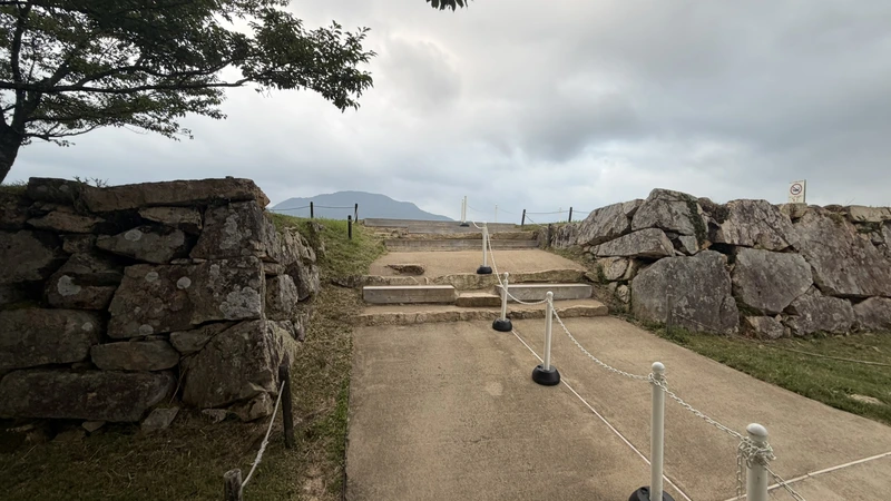 The passage into Ninomaru, seen head-on between stone walls, with a narrow gate-like entrance still visible.