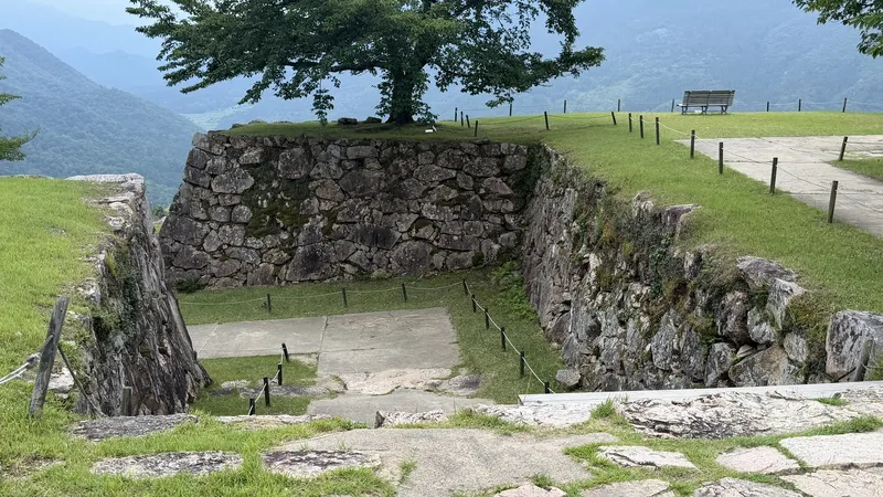A bending passage enclosed by stone walls near Sannomaru, seen looking down from above.