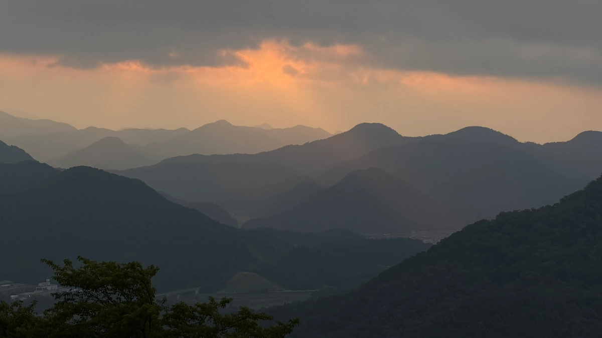 Morning sunlight breaking through clouds at Tenshudai, Takeda Castle Ruins