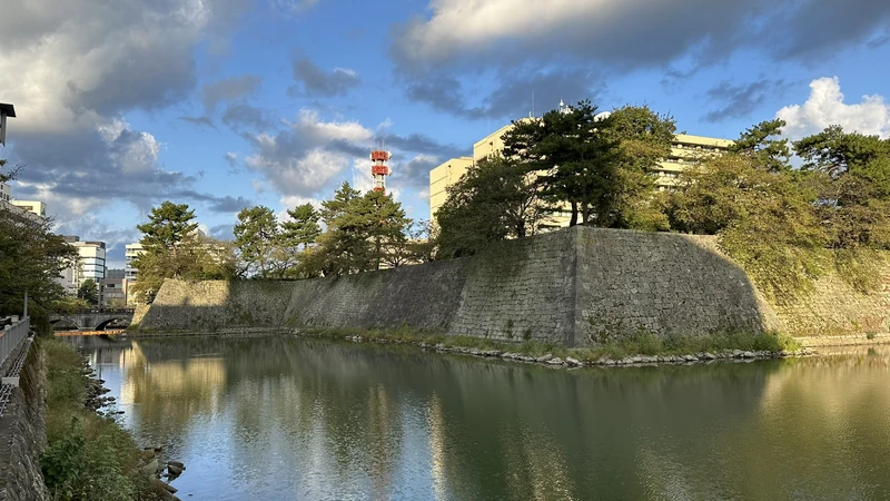 The moat and high stone walls of Fukui Castle