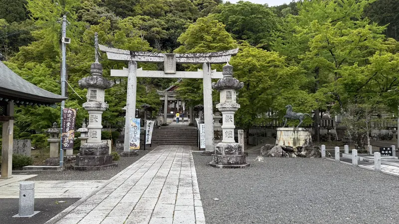 The grounds' entrance, lined with stone lanterns and komainu statues