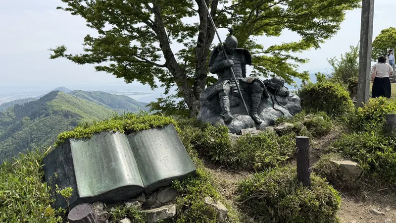 Sculpture with a book-shaped plaque