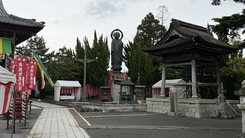 Full view of the roughly 6-meter bronze Enmei Jizo statue standing outdoors