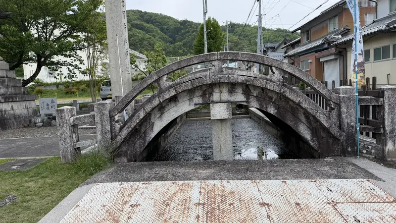 A stone bridge crossing the grounds of Ohofura Shrine