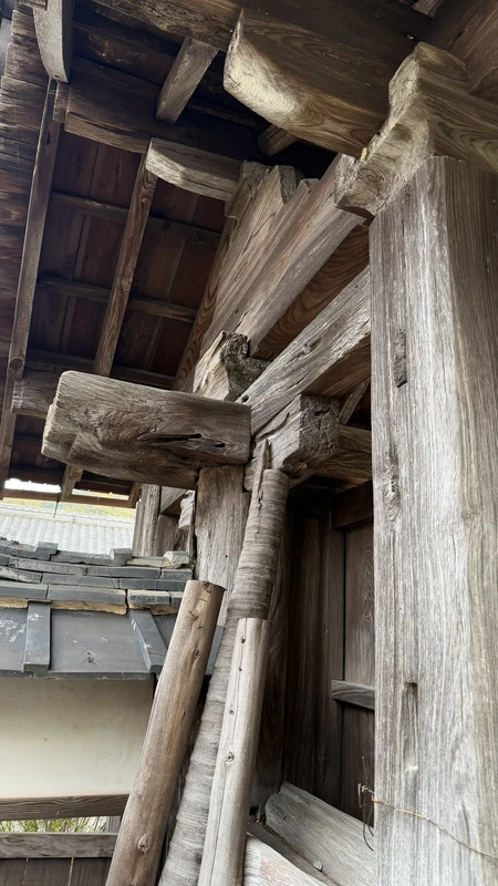 A close-up looking up at the posts and beams of Chokoji Temple's gate, showing how the thick timbers are joined together.