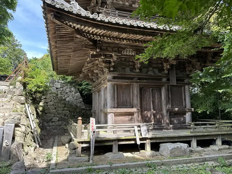 A close-up view of the ground floor of the Three-Story Pagoda, showing the doors, veranda, and intricate eave bracketing.