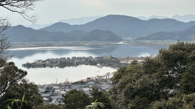 A view of the lake and mountains from near Sōken-ji's former main hall site, with the town of Azuchi visible below.