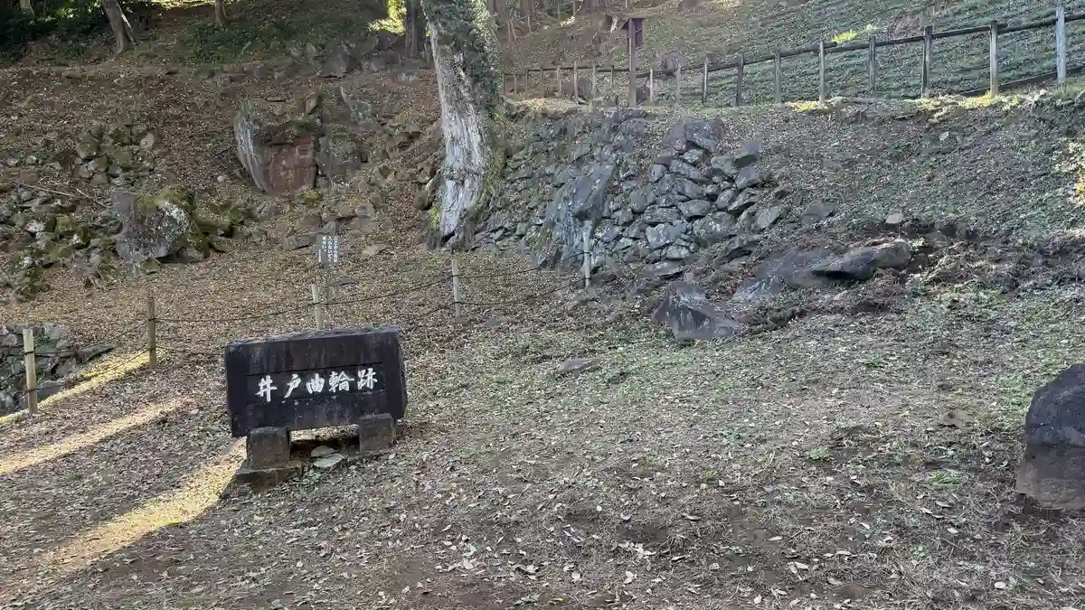 Stone marker and walling at the base of the well enclosure
