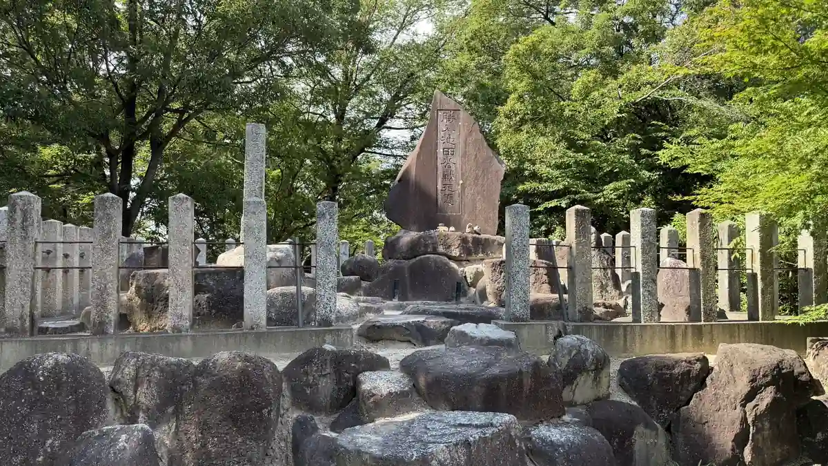 Stone monument and stone fence at Shonyuzuka surrounded by trees