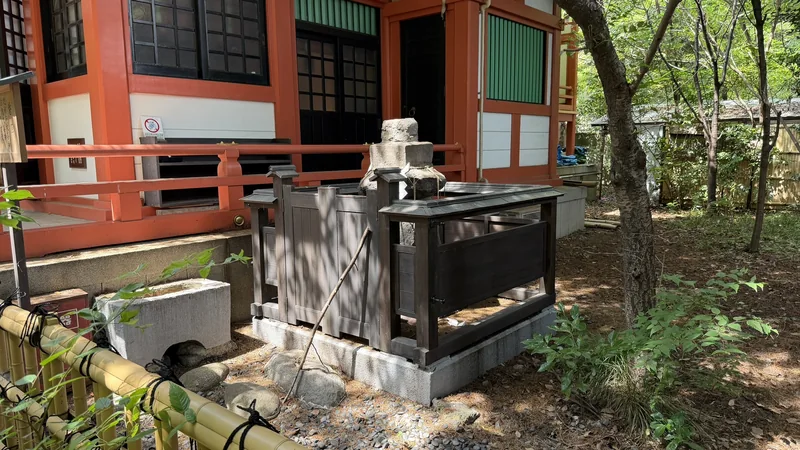 Sacred rock enclosed by bamboo fencing beside the Shiba Toshogu worship hall