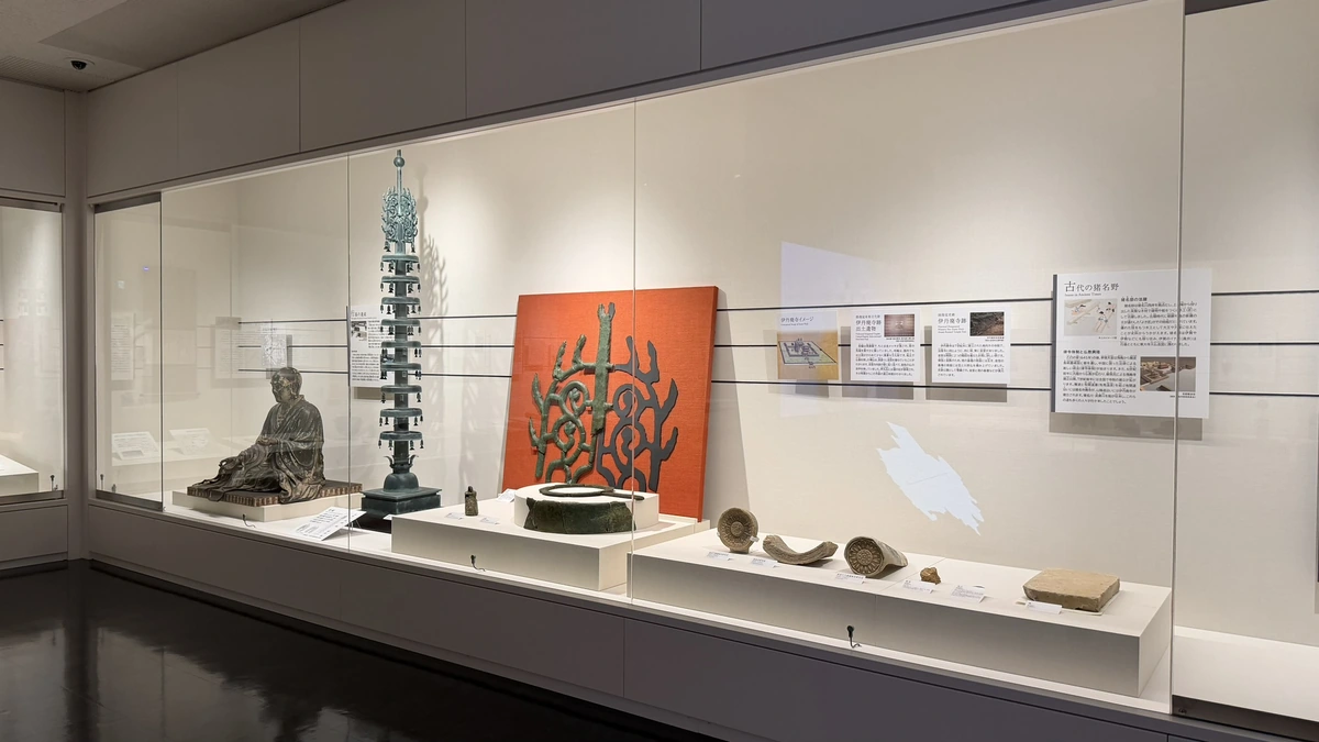 Display case of Buddhist statuary, roof tiles and cast metalwork from ancient Itami