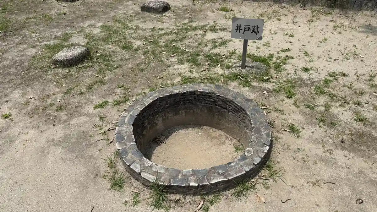Circular stonework marking the excavated well at Arioka Castle