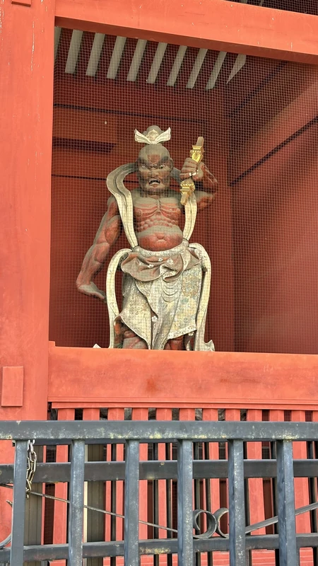 Wooden Nio guardian holding a weapon at the former Taitoku-in gate