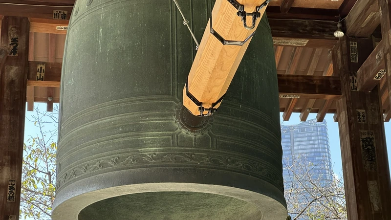 Big bell and wooden striker inside the pavilion