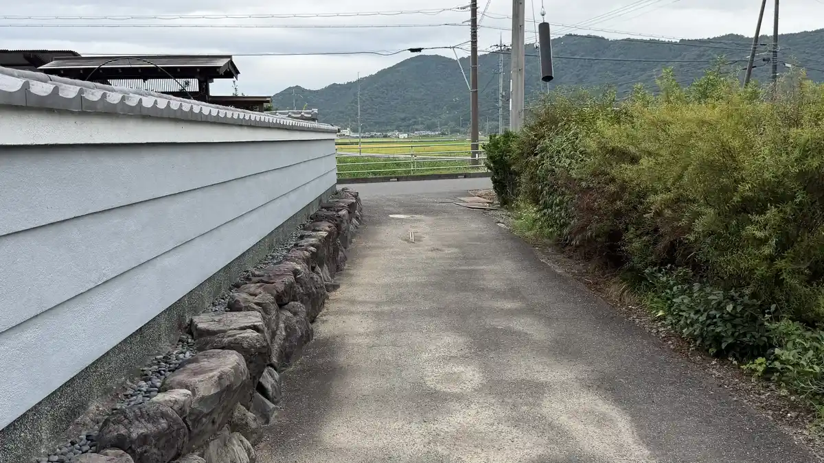 山林を出た先、白壁と石垣に沿って続く集落の細道。ここから安土駅方面へ戻ります。