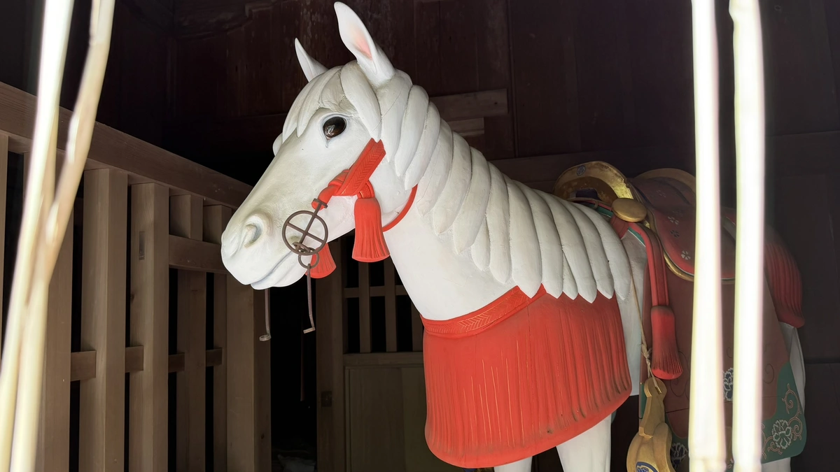 Close view of the white wooden horse enshrined in the sacred stable at Kunozan Toshogu