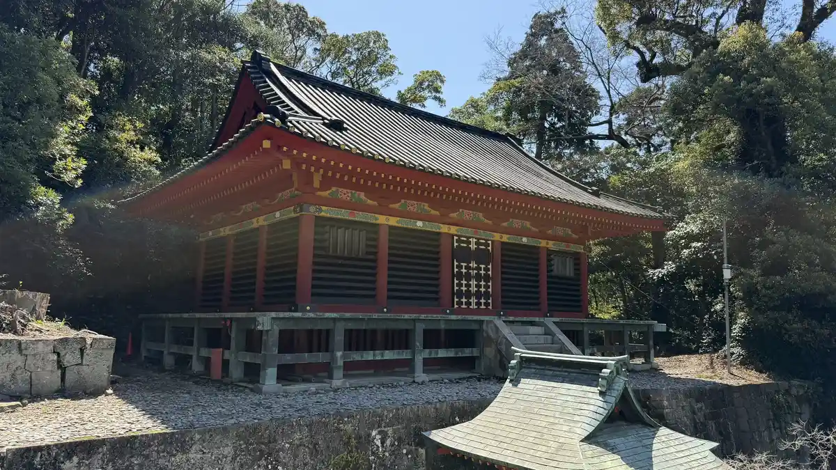 The vermilion side elevation and roof of Hie Shrine photographed from higher ground