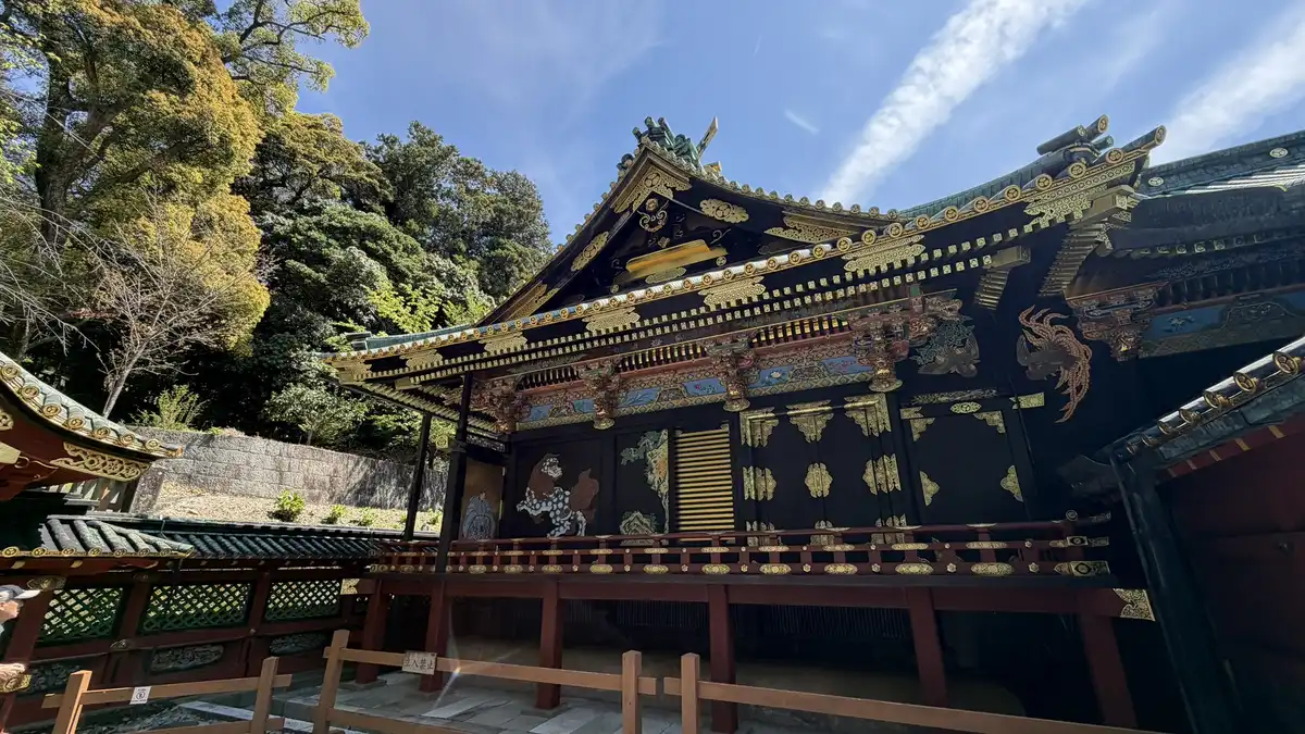 The National Treasure shrine buildings at an angle, showing black fittings, vermilion railings and carving