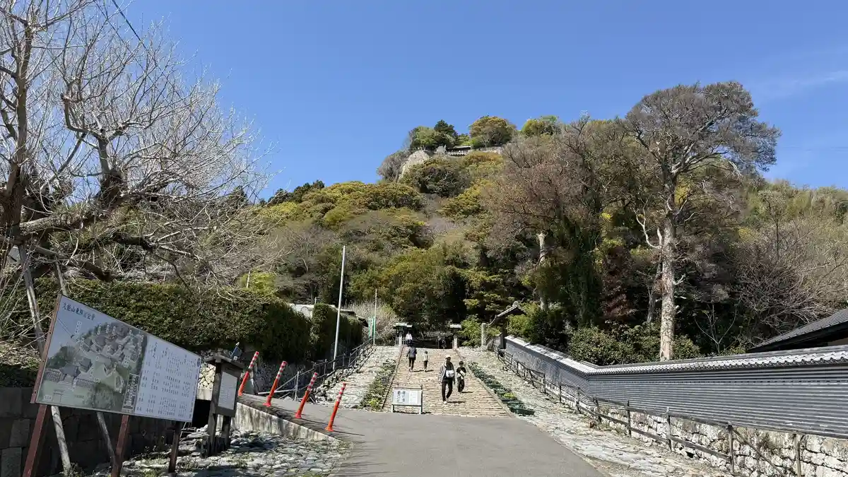 The approach path running along the rock face of Kunozan with trees on the slope