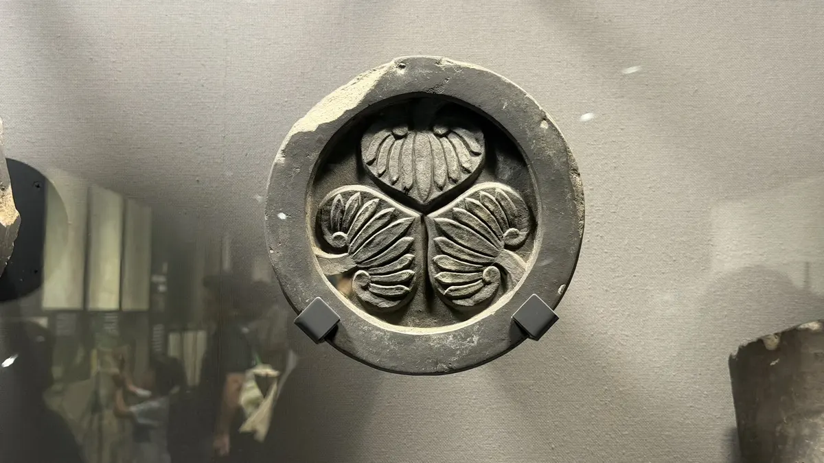 Excavated roof tile bearing the triple-hollyhock crest
