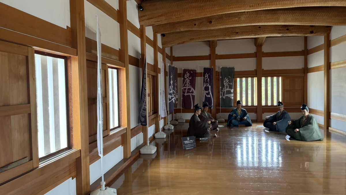 Seated samurai figures in the room above the Akagane Gate