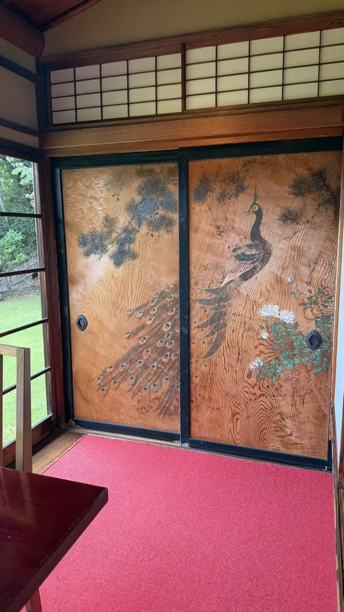 Sliding doors painted with peacocks on a gold ground