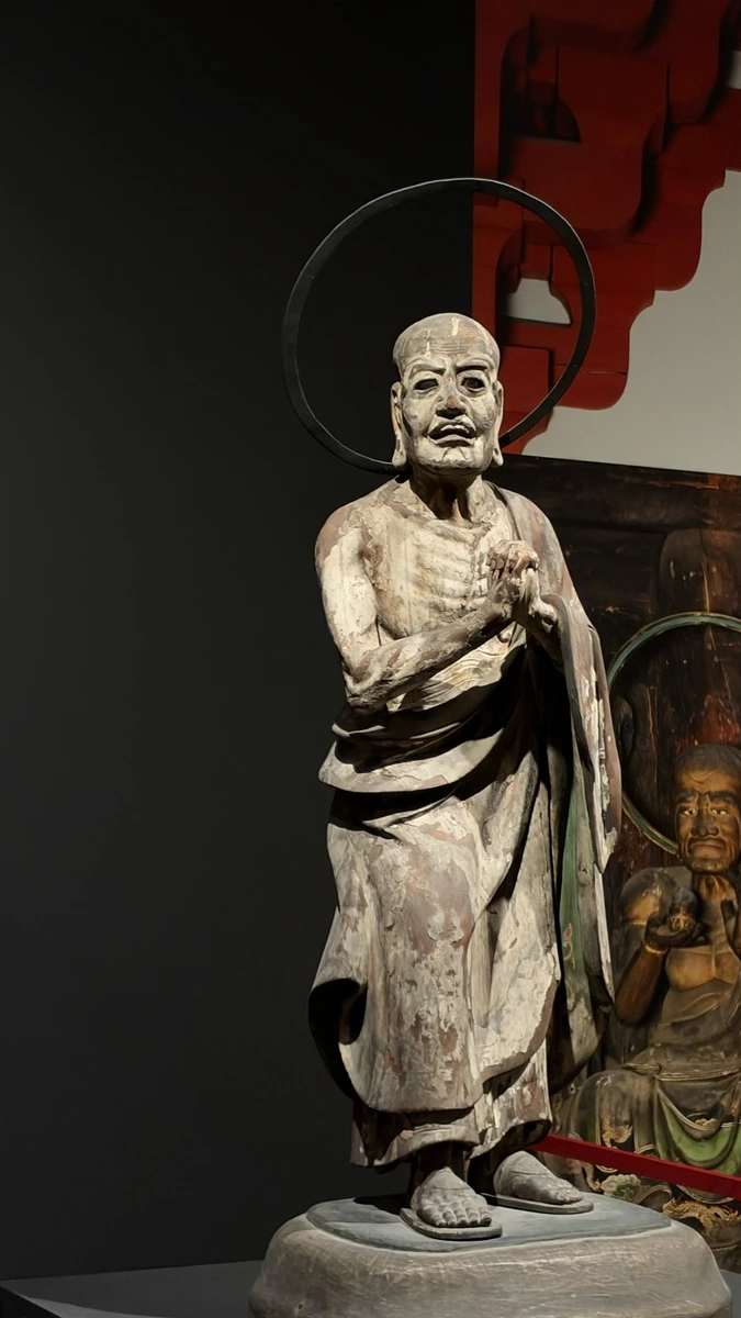 The elderly disciple Kashyapa standing with joined hands and a circular halo